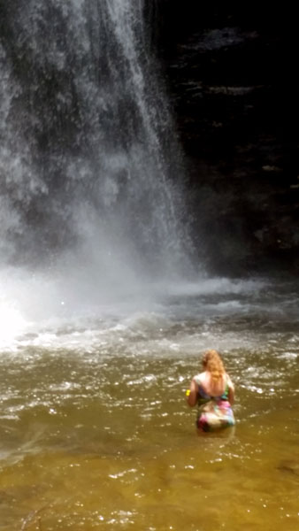 Karen Duquette in the water at Looking Glass Falls